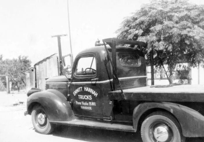 A black and white photo of an old truck.